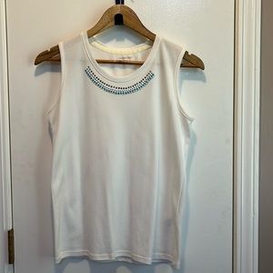 White sleeveless top with blue, silver, and clear rhinestones on neckline.